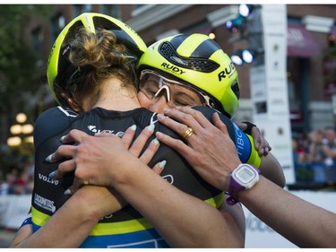 Kendall Ryan ( right ) is hugged by teammates after winning  the women's  35 lap / 42 km Global Relay Gastown Grand Prix , Vancouver, July 12 2017.