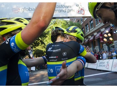 Kendall Ryan (Centre ) reaches out as she is hugged by a teammate after winning  the women's  35 lap / 42 km Global Relay Gastown Grand Prix , Vancouver, July 12 2017.