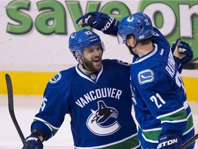 Mason Raymond celebrates a goal  Andrew Ebbett in March 2013.