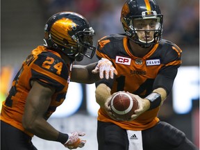 Travis Lulay hands the ball off to Jeremiah Johnson during the B.C. Lions' wild 45-42 win over the Winnipeg Blue Bombers Friday night at B.C. Place.Gerry Kahrmann, PNG