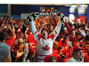 Fans in Canada House cheer Canada's 3-2 gold medal victory over the U.S. on Feb. 28, 2010 at the 2010 Vancouver Olympic Winter Games. The event capped a successful event in which Canada won a record 14 gold medals.