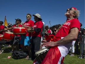 Dozens of drummers, including Kenny Lord, a full-time musician who normally plays with his blues band Lord Knapp, take part in the  150 Atlantic to Pacific Drumming celebration at Creekside Park in Vancouver, BC Saturday, July 1, 2017. The coast-to-coast event aimed to set a new world record for simultaneous drumming across the country by Canadians from nations all around the world. Pictured are drummers warming up the crowd before the event.  (Photo by Jason Payne/PNG)