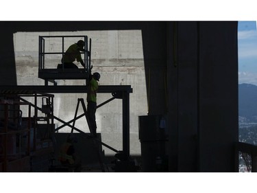 Workers on the top floor of the 55-storey Civic Hotel in Surrey