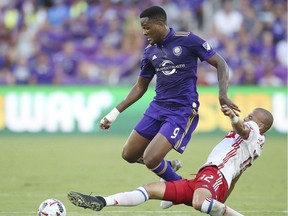 Toronto FC's Jason Hernandez tackles Orlando City's Cyle Larin during an MLS soccer match Wednesday, July 5, 2017, in Orlando, Fla.