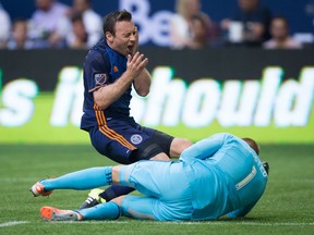 New York City FC's Tommy McNamara goes down like a ton 
of bricks behind Whitecaps goalkeeper David Ousted during Wednesday's game at B.C. Place. McNamara earned a penalty kick for his efforts.