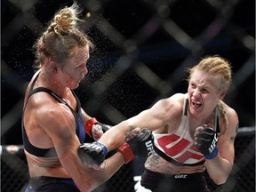 Valentina Shevchenko, right, of Kyrgyzstan, follows through on a punch to Holly Holm during a women's bantamweight mixed martial arts bout in Chicago. Shevchenko is a Soviet-born Peruvian from Kyrgyzstan who does her mixed martial arts training in Thailand and the U.S. This avid traveler, dance contest winner and recent restaurant shooting survivor also might be the UFC's new bantamweight champion after her rematch with Amanda Nunes on Saturday.