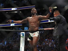 Jon Jones celebrates after knocking out Daniel Cormier in their UFC light heavyweight championship bout during the UFC 214 event at Honda Center on July 29, 2017 in Anaheim, California.