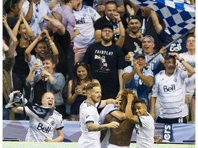 Yordy Reyna is mobbed by Vancouver teammates after scoring the winning goal Wednesday against New York City FC in a MLS match at B.C. Place Stadium.