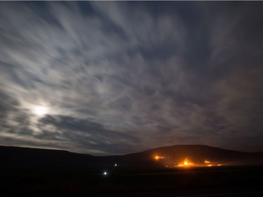 The moon illuminates clouds and smoke as a wildfire burns on a mountain near Ashcroft, B.C., late Friday July 7, 2017. More than 3,000 residents have been evacuated from their homes in central British Columbia. A provincial state of emergency was declared after 56 new wildfires started Friday. THE CANADIAN PRESS/Darryl Dyck ORG XMIT: VCRD119
DARRYL DYCK,