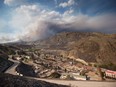 The remains of mobile homes destroyed by wildfire are seen in Boston Flats as a fire burns on a mountain near Ashcroft, B.C., on Sunday, July 9, 2017.