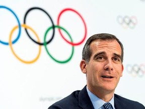 FILE - In this July 11, 2017 file photo Mayor of Los Angeles Eric Garcetti speaks, during a press conference after the International Olympic Committee (IOC) Extraordinary Session, at the SwissTech Convention Centre, in Lausanne, Switzerland. It was announced Monday, July 31, 2017 that Los Angeles has reached an agreement with international Olympic leaders that will open the way for the city to host the 2028 Summer Games, while ceding the 2024 Games to rival Paris. Ôªø(Jean-Christophe Bott/Keysto