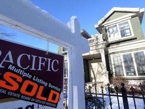 A real estate sold sign is shown outside a house in Vancouver, Tuesday, Jan.3, 2017. The Real Estate Board of Greater Vancouver says the typical price of a home in Metro Vancouver has surpassed $1 million. THE CANADIAN PRESS/Jonathan Hayward