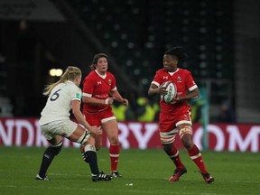 Canadian rugby forward Latoya Blackwood, right, runs with the ball in a 39-6 loss to England at Twickenham, London, on November 26, 2016. THE CANADIAN PRESS/HO-Mundo Rugby/TrySportimages, Martin Seras Lima, *MANDATORY CREDIT*