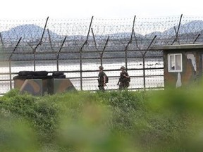 South Korean army soldiers patrol along the barbed-wire fence in South Korea&#039;s Paju, near the border with North Korea, Friday, Aug. 11, 2017. Military officials said Friday they plan to move ahead with large-scale U.S.-South Korea exercises later this month that North Korea, now finalizing plans to launch a salvo of missiles toward Guam, claims are a rehearsal for war. (AP Photo/Ahn Young-joon)