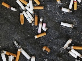 FILE - This Thursday, Sept. 17, 2015 file photo shows an ashtray with cigarette butts outside the Oklahoma County Courthouse in Oklahoma City. Researchers found that smokers who switched to special low-nicotine ones wound up smoking less and were more likely to try to quit, according to a new study published in the New England Journal of Medicine on Wednesday, Sept. 30, 2015. (AP Photo/Sue Ogrocki)