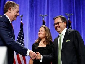 U.S. Trade Representative Robert Lighthizer (left) shakes hands with Mexico's Secretary of Economy Ildefonso Guajardo Villarreal, accompanied by Canadian Foreign Affairs Minister Chrystia Freeland.