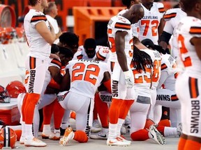 Members of the Cleveland Browns kneel during the national anthem before an NFL preseason football game between the New York Giants and the Cleveland Browns, Monday, Aug. 21, 2017, in Cleveland. (AP Photo/Ron Schwane)