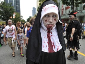 Zombies ham it up on Robson Street during the 2012 Vancouver Zombiewalk. It's on again Saturday.