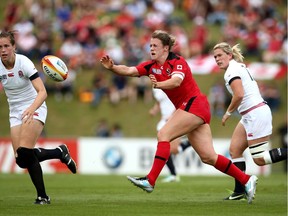 Andrea Burk passes the ball during the IRB Women's Rugby World Cup Pool A match between England and Canada at the French Rugby Federation headquarters on August 9, 2014.