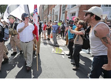 CHARLOTTESVILLE, VA - AUGUST 12:  Hundreds of white nationalists, neo-Nazis and members of the "alt-right" are confronted by protesters as they march down East Market Street toward Lee Park during the "United the Right" rally August 12, 2017 in Charlottesville, Virginia. After clashes with anti-facist protesters and police the rally was declared an unlawful gathering and people were forced out of Lee Park, where a statue of Confederate General Robert E. Lee is slated to be removed.