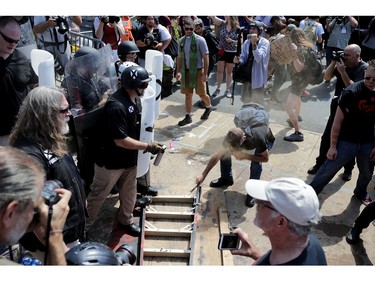 CHARLOTTESVILLE, VA - AUGUST 12:  White nationalists, neo-Nazis and members of the "alt-right" clash with counter-protesters as they attempt to guard the entrance to Lee Park during the "Unite the Right" rally August 12, 2017 in Charlottesville, Virginia. After clashes with anti-fascist protesters and police the rally was declared an unlawful gathering and people were forced out of Lee Park, where a statue of Confederate General Robert E. Lee is slated to be removed.
