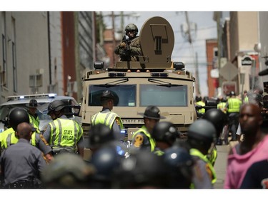 CHARLOTTESVILLE, VA - AUGUST 12:  A Virginia State Police officer in riot gear keeps watch from the top of an armored vehicle after car plowed through a crowd of counter-demonstrators marching through the downtown shopping district August 12, 2017 in Charlottesville, Virginia. The car plowed through the crowed following the shutdown of the "Unite the Right" rally by police after white nationalists, neo-Nazis and members of the "alt-right" and counter-protesters clashed near Lee Park, where a statue of Confederate General Robert E. Lee is slated to be removed.