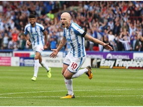 Star midfielder Aaron Mooy of Huddersfield Town celebrates scoring his side's first goal during the Premier League match between Huddersfield Town and Newcastle United at John Smith's Stadium on Aug. 20, 2017 in Huddersfield, England.