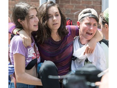 People receive first-aid after a car accident ran into a crowd of protesters in Charlottesville, VA on August 12, 2017.  A picturesque Virginia city braced Saturday for a flood of white nationalist demonstrators as well as counter-protesters, declaring a local emergency as law enforcement attempted to quell early violent clashes.