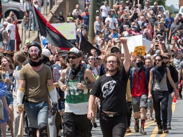 Protesters march in Charlottesville, Virginia on August 12, 2017.  A picturesque Virginia city braced Saturday for a flood of white nationalist demonstrators as well as counter-protesters, declaring a local emergency as law enforcement attempted to quell early violent clashes.