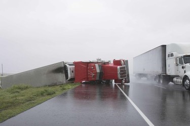 A big rig lies on it's side on Hwy 59 near Edna, Texas, south of Houston, in the aftermath of Hurricane Harvey on August 26, 2017.