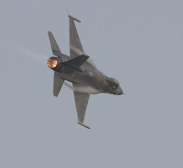 Water vapour forms along the wings as a U.S. F-16  performs at the Abbotsford Airshow.