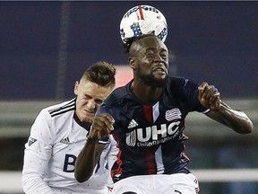 New England Revolution forward Kei Kamara heads the ball in front of Vancouver Whitecaps defender Jake Nerwinski during an Aug. 12, 2017 game.
