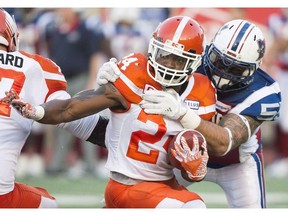 Montreal Alouettes' defensive end Gabriel Knapton tackles B.C. Lions running back Jeremiah Johnson during CFL action in Montreal on July 6, 2017.