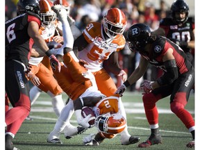 Chris Rainey of the B.C. Lions gets upended Saturday as he runs the ball against the Ottawa Redblacks during the second half of a Canadian Football League game in Ottawa. The Redblacks won 31-24.