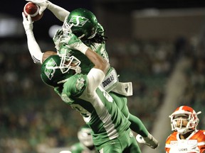 Saskatchewan Roughriders defender Ed Gainey out-leaps teammate Duron Carter to record his fourth interception during second-half CFL action against the B.C. Lions in Regina on Sunday.