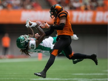 Saskatchewan Roughriders' Naaman Roosevelt, left, fails to make the reception as B.C. Lions' Loucheiz Purifoy defends during the second half of a CFL football game at B.C. Place on Saturday.