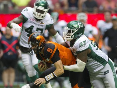 BC Lions #9 Alex Ross is tackled by Saskatchewan Roughriders #98 Ese Mrabure in a regular season CHL football game at BC Place Vancouver, August 05 2017.