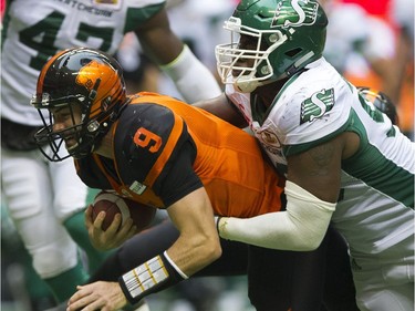 BC Lions #9 Alex Ross is tackled by Saskatchewan Roughriders #98 Ese Mrabure in a regular season CHL football game at BC Place Vancouver, August 05 2017.