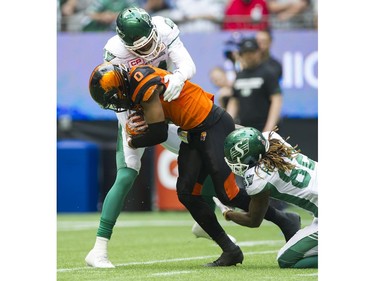 Saskatchewan Roughriders #81 Bakari Grant and #82 Naaman Roosevelt wrap up BC Lions #0 Loucheiz Purifoy after he recovered a loose ball in a regular season CHL football game at BC Place Vancouver, August 05 2017.