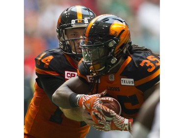 BC Lions #14 Travis Lulay hands off the ball to #35 Shaquille Murray-Lawrence for a touchdown run against the Saskatchewan Roughriders in a regular season CHL football game at BC Place Vancouver, August 05 2017.
