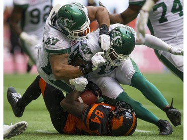 A pair of Saskatchewan Roughriders tackle BC Lions #84 Emmanuel Arceneaux  in a regular season CHL football game at BC Place Vancouver, August 05 2017.