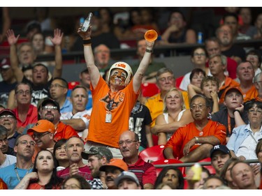 A fan raises his arms as the BC Lions play the Saskatchewan Roughriders in a regular season CHL football game at BC Place Vancouver, August 05 2017.