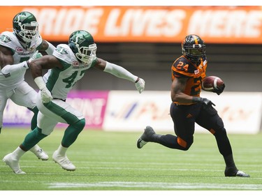 BC Lions #24 Jeremiah Johnson eludes a pair of  Saskatchewan Roughriders in a regular season CHL football game at BC Place Vancouver, August 05 2017.