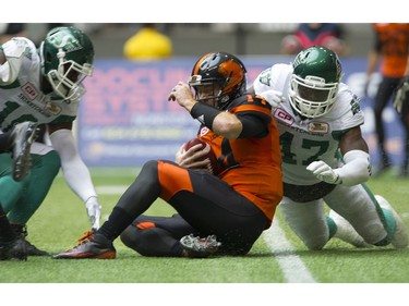 BC Lions #14 Travis Lulay slides safely while covered by  Saskatchewan Roughriders #47 Samuel Eguavoen in a regular season CHL football game at BC Place Vancouver, August 05 2017.
