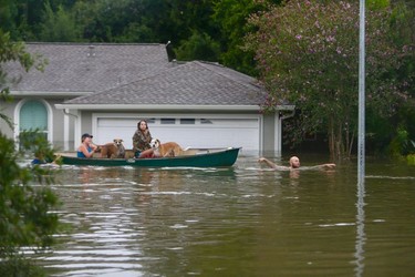 A family evacuates their Meyerland home in Houston, Sunday, Aug. 27, 2017.