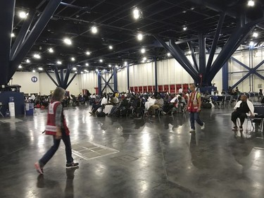 People seek shelter from the aftermath of Hurricane Harvey at the George R. Brown Convention Center in Houston on Sunday, Aug. 27, 2017. Rising floodwaters from the remnants of Hurricane Harvey chased thousands of people to rooftops or higher ground Sunday in Houston, overwhelming rescuers who fielded countless desperate calls for help. (Elizabeth Conley/Houston Chronicle via AP) ORG XMIT: TXHOU109

MANDATORY CREDIT
Elizabeth Conley, AP