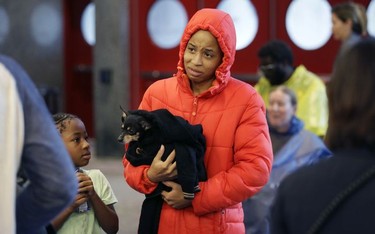 D'Ona Spears, center, reacts as she is told that she cannot bring her dog Missy into the shelter for flood evacuees with her daughter Natalie, left, at the convention center in downtown Houston, Texas, Sunday, Aug. 27, 2017. Spears and her family walked to the shelter after her home was flooded with water from the Buffalo Bayou. (AP Photo/LM Otero) ORG XMIT: TXMO102
LM Otero, AP