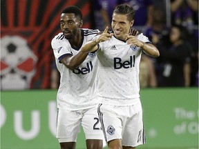 Vancouver Whitecaps's Aaron Maund, left, and Nicolas Mezquida celebrate after Orlando City scored a goal against themselves during the first half of their game in Orlando last month. The skilled and dangerous Mezquida is the perfect example of the depth the Caps' bench has.