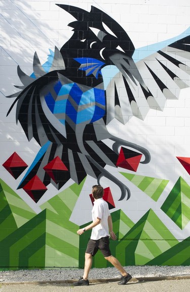 A man checks out a mural by Carrielynn Victor at the Vancouver Mural Festival.