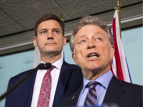 Environment Minister George Heyman, right, and Attorney General David Eby announced the B.C. government's plans to fight Kinder Morgan's Trans Mountain pipeline expansion project Thursday in Vancouver.